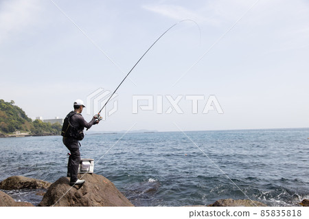 A man fishing on the rocky shore A man fishing on the rocky shore 85835818