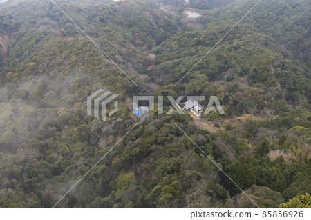 Building in a cloudy forest 85836926
