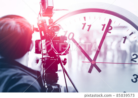 video camera man in media news broadcasting industry working overlay with time clock for work against time concept video camera man in media news broadcasting industry working overlay with time clock for work against time concept 85839573