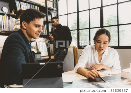 Smart Asian working women discuss project with male team work in modern office 85839887