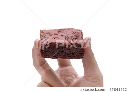 hand holding cake chocolate brownies isolated on white background - clipping paths hand holding cake chocolate brownies isolated on white background - clipping paths 85841312