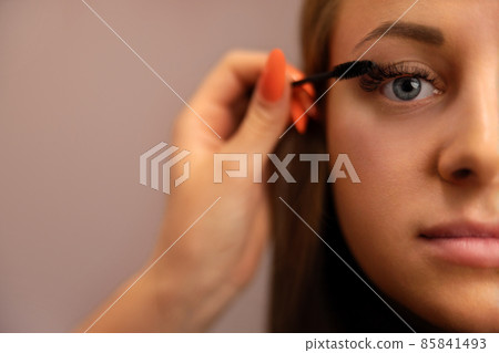 Portrait Of Woman With Cosmetologist Hand Using Mascara Portrait Of Woman With Cosmetologist Hand Using Mascara 85841493