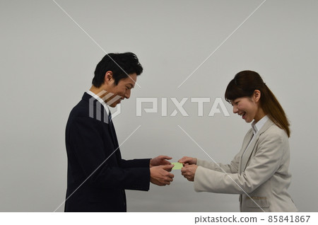 Men and women exchanging business cards 85841867