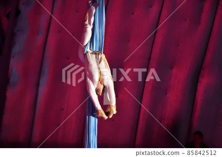 A young aerial gymnast performs her number on ribbons A young aerial gymnast performs her number on ribbons 85842512