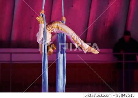 A young aerial gymnast performs her number on ribbons A young aerial gymnast performs her number on ribbons 85842513