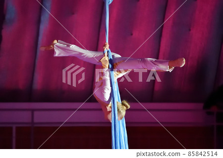 A young aerial gymnast performs her number on ribbons A young aerial gymnast performs her number on ribbons 85842514