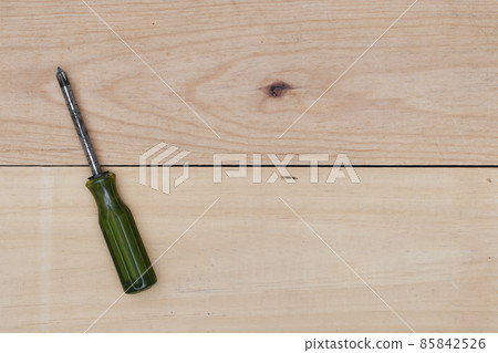 screwdriver on wooden background. 85842526