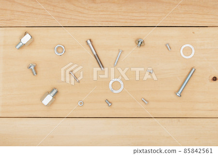 metal bolt and nut on wooden background. metal bolt and nut on wooden background. 85842561