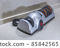Modern electric knife sharpener in the home kitchen 85842565