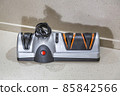 Modern electric knife sharpener in the home kitchen 85842566