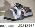 Modern electric knife sharpener in the home kitchen 85842567