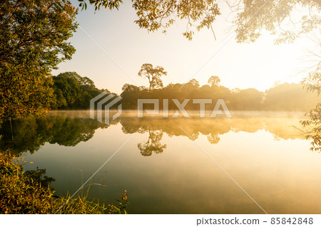 Morning fog lifts off a lake state sunrise on a cool September morning Morning fog lifts off a lake state sunrise on a cool September morning 85842848