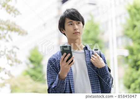 Young man with a smartphone 85845047