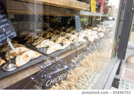 Triangular tapestries lined up by the bakery window in Richmond, a suburb of London 85846702