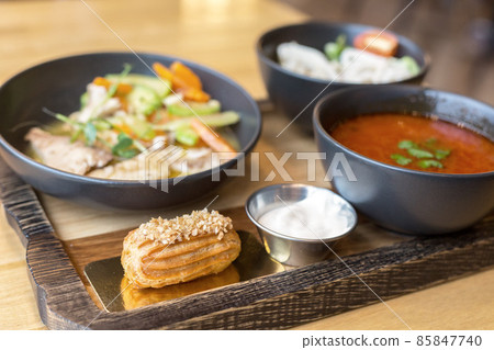 A full lunch at the restaurant borscht salad sweet cake served on a wooden board A full lunch at the restaurant borscht salad sweet cake served on a wooden board 85847740