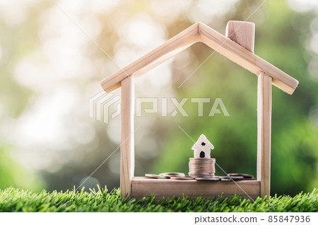 House on the coins placed in a model house on the grass. planning savings money of coins to buy a home House on the coins placed in a model house on the grass. planning savings money of coins to buy a home 85847936