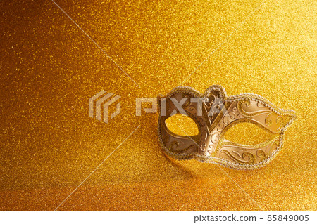 Carnival mask on a glitter golden background Carnival mask on a glitter golden background 85849005