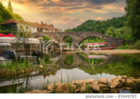 Arched bridge at sunset 85849783