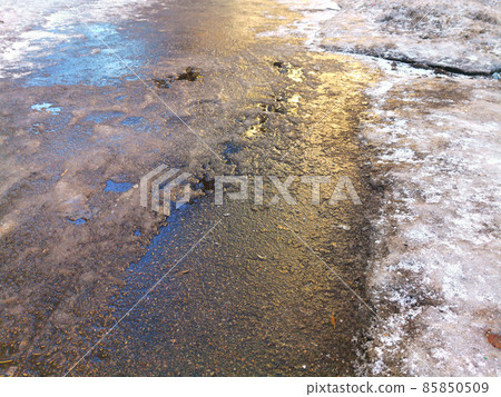 asphalt road covered with ice, slippery road winter 85850509