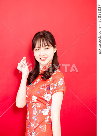 A hand-shaped hand-shaped gesture for a red background with a flag sword written by a female cheongsam. A hand-shaped hand-shaped gesture for a red background with a flag sword written by a female cheongsam. 85851837
