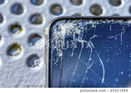 A smartphone with a broken screen when dropped 85851989