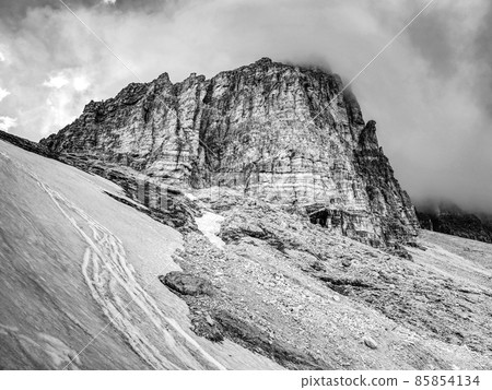 Tre Cime di Lavaredo rocks hidden in gentle fog. Early summer Tre Cime di Lavaredo rocks hidden in gentle fog. Early summer 85854134
