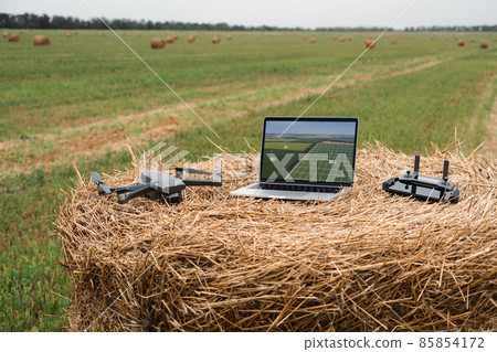 Laptop and drone on the field 85854172