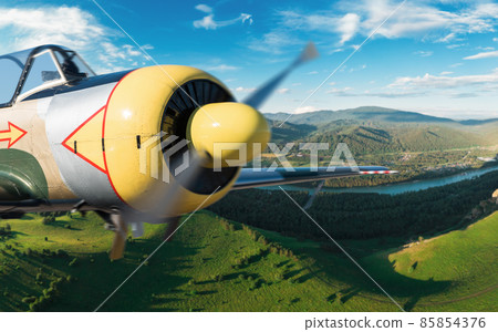 Small aircraft flying above in the blue sky 85854376