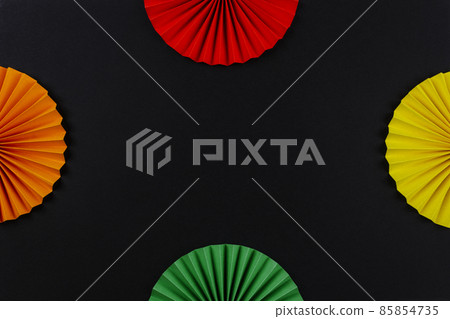 Red, orange, yellow and green color paper origami flowers on the black background. Black History Month concept. Red, orange, yellow and green color paper origami flowers on the black background. Black History Month concept. 85854735