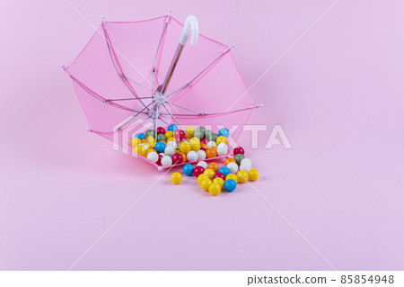Upturned umbrella with caramel candy. Concept for Dia de Reyes Magos day (Three Wise Men) or Epiphany day. Upturned umbrella with caramel candy. Concept for Dia de Reyes Magos day (Three Wise Men) or Epiphany day. 85854948