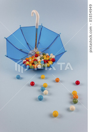 Upturned umbrella with caramel candy. Concept for Dia de Reyes Magos day (Three Wise Men) or Epiphany day.  85854949