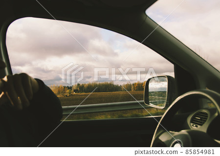 Man drives a car. View through the moving car windscreen. 85854981