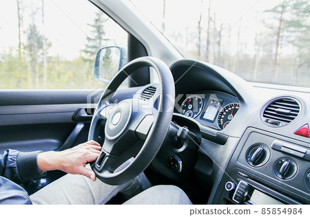 Man drives acar. View through the moving car windscreen. Man drives acar. View through the moving car windscreen. 85854984