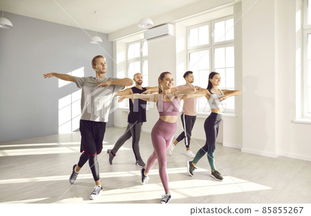 Smiling young people in sportswear train dance Stock Photo