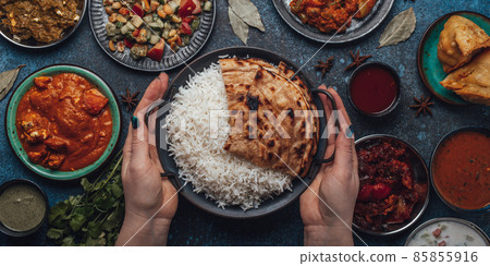 Assorted Indian ethnic food buffet on rustic concrete table from above Assorted Indian ethnic food buffet on rustic concrete table from above 85855916