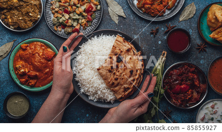 Assorted Indian ethnic food buffet on rustic concrete table from above Assorted Indian ethnic food buffet on rustic concrete table from above 85855927