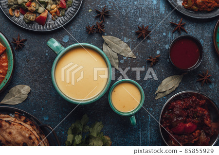 Healthy Indian Ayurveda drink mango lassi in two cups on rustic concrete table Healthy Indian Ayurveda drink mango lassi in two cups on rustic concrete table 85855929