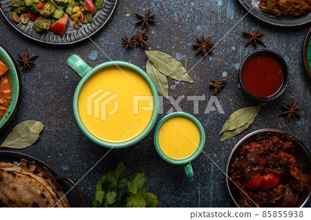 Healthy Indian Ayurveda drink mango lassi in two cups on rustic concrete table Healthy Indian Ayurveda drink mango lassi in two cups on rustic concrete table 85855938