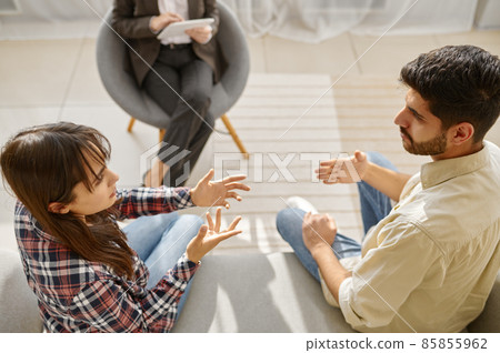 Couple having emotional speech during therapy session Couple having emotional speech during therapy session 85855962