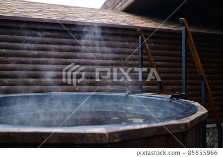 Wooden bathtub with stove on outside terrace 85855966