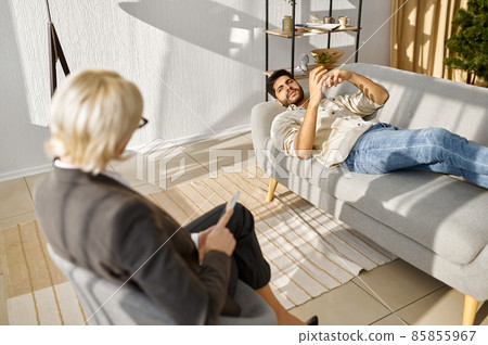 Emotional young patient explaining opinion to psychologist 85855967