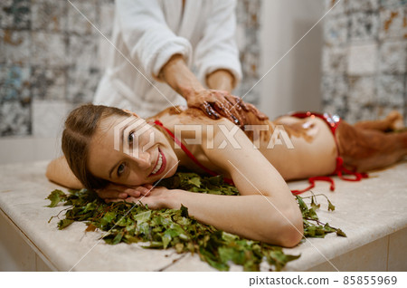 Young woman getting honey massage in sauna 85855969