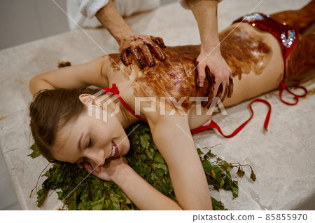 Young woman getting honey massage in sauna 85855970
