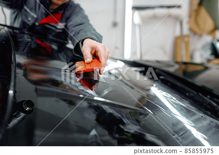 Auto service worker coating luxury black car 85855975