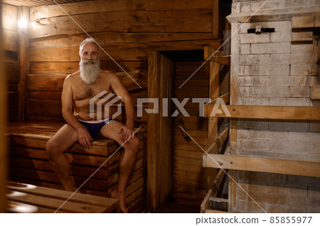 Grey-haired senior man rest at bath house 85855977