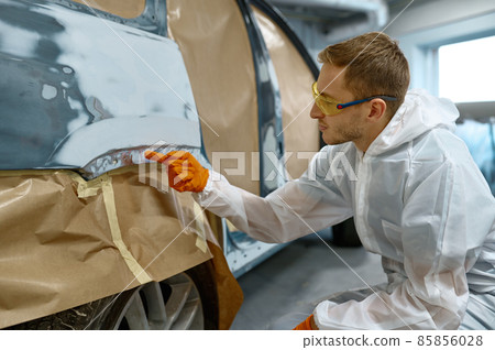 Repairman checking quality of old paint removal Repairman checking quality of old paint removal 85856028