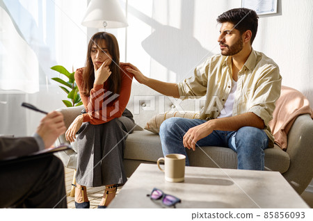 Upset married couple during family therapy 85856093