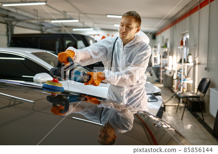 Professional car service worker polishing painted surface Professional car service worker polishing painted surface 85856144