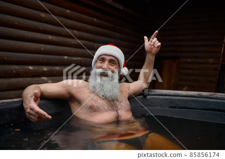 Santa Claus resting in bath vat outside 85856174