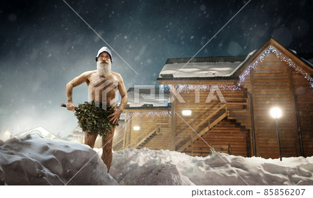 Man covers with broom stand over snow 85856207